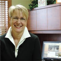 Candace Shira of Candace Shira Associates, LLC. smiling in an office.