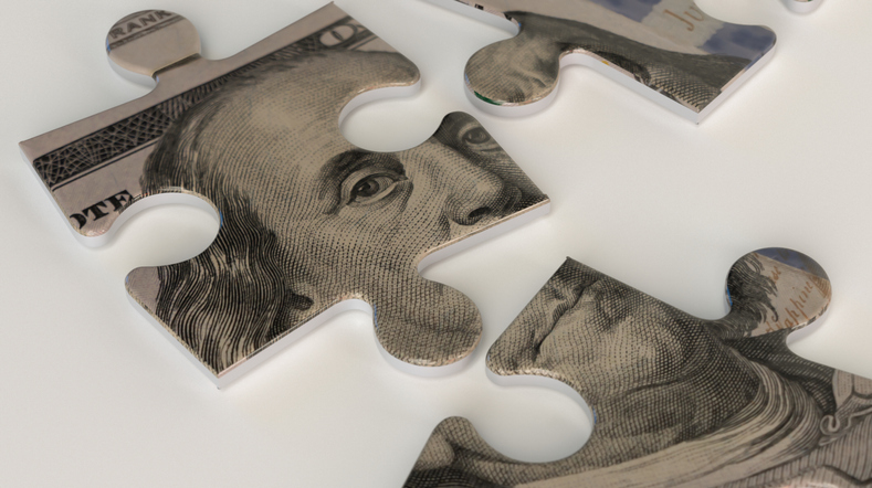 Puzzle pieces with a hundred dollar bill design.