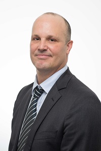 Professional headshot of a man in a suit and tie.