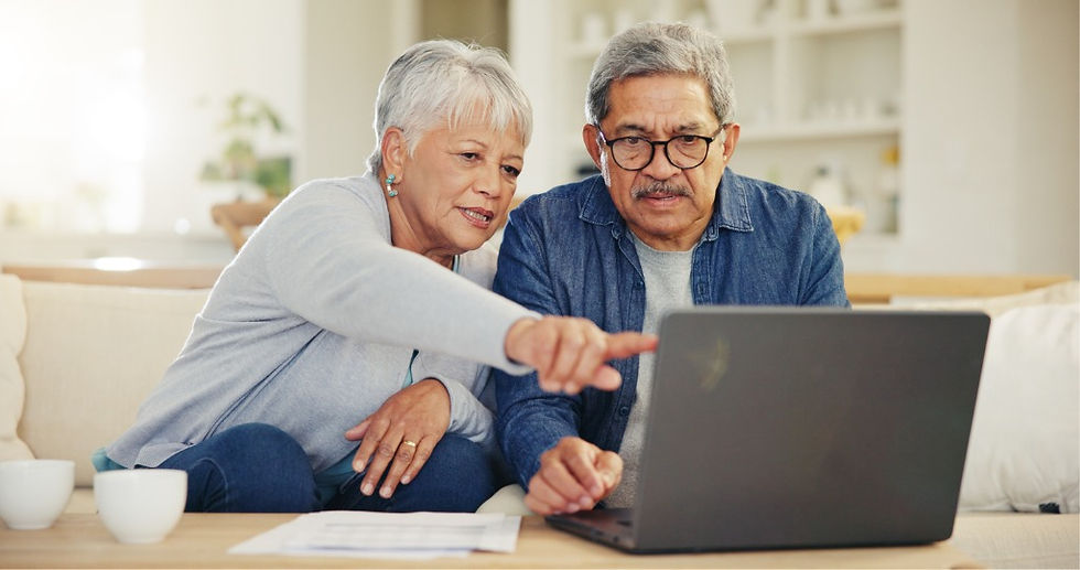 Senior couple using a laptop together at home.