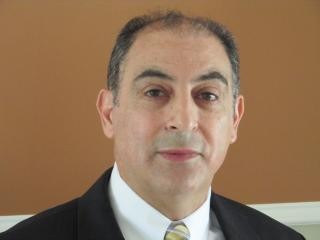 Professional headshot of a man in a suit and tie