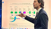 Roger Zaldivar giving presentation in front of ophthalmic lens sizing chart