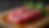 Close-up view of fresh beef liver on a wooden cutting board
