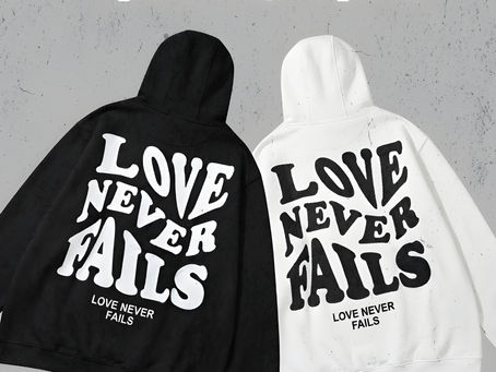 Stylish "Love Never Fails" couple hoodies from Kins Clothing, crafted with premium quality for a cozy and meaningful statement.