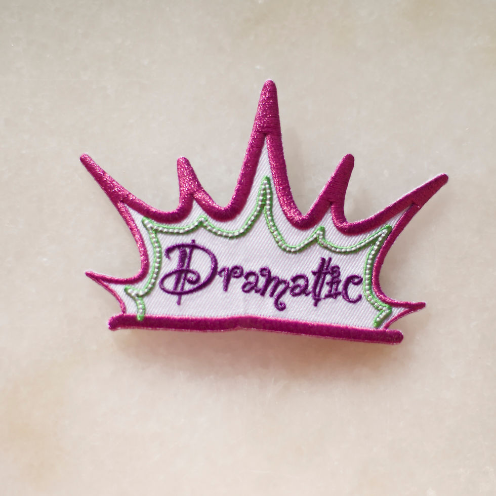 Embroidered badge with the word 'dramatic'