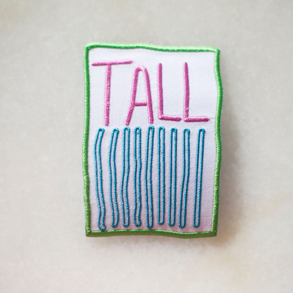 Embroidered badge with the word 'tall'