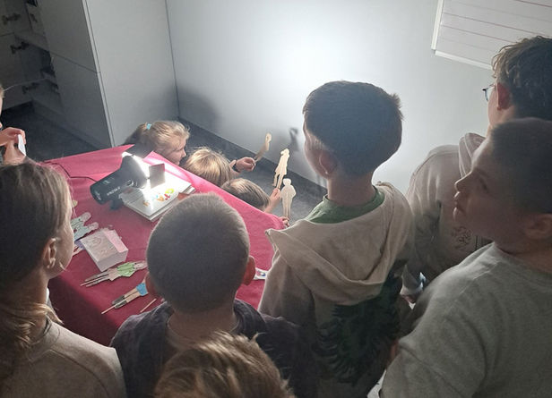 Uczniowie bawiący się i obserwujący przedstawienie.