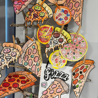 Dekoracja - kolorowanki kawałki pizzy wycięte z papieru i zawieszone na ścianie