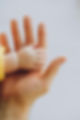 Baby hand holding adult hand.