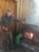 Steve Snyder feeding the evaporator in the sugar house at Gould Farm. Photo from Berkshire Edge by Hannah Van Sickle.