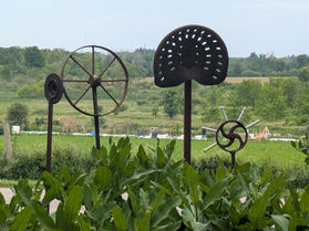 Farm implement sculptures on the campus of the Ignatius Jesuit Centre in Guelph, Ontario.