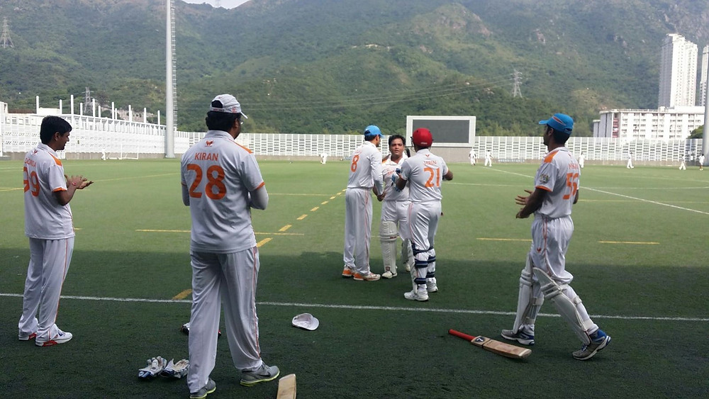 Jigar Parikh congratulated by his teammates after his century.