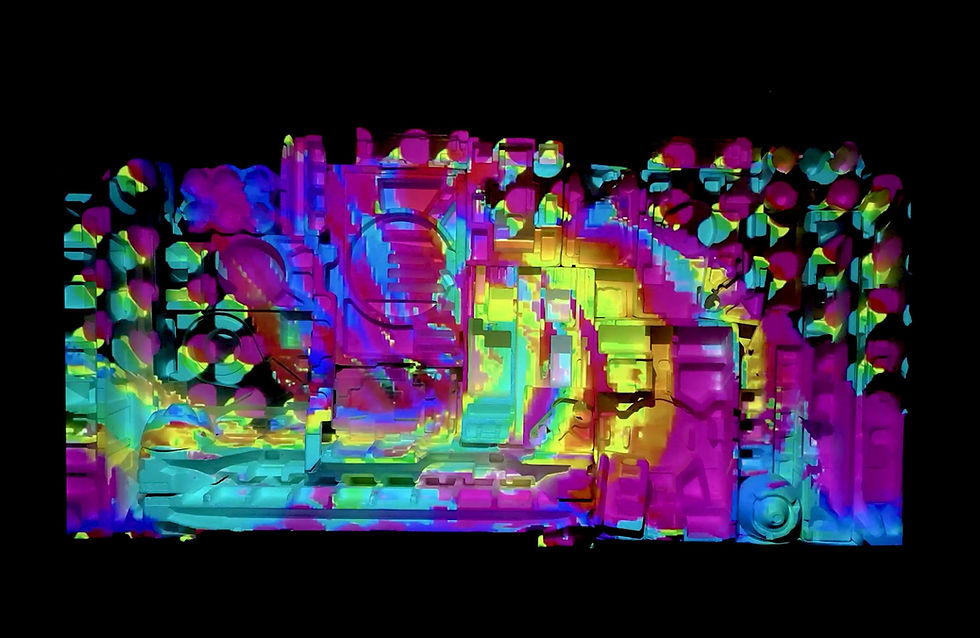 A colorful light display forecast over a 3D sculpture.
