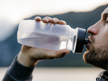 man drinking from water bottle