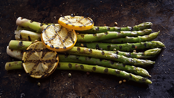 Grilled asparagus topped with grilled lemon slices and salt.