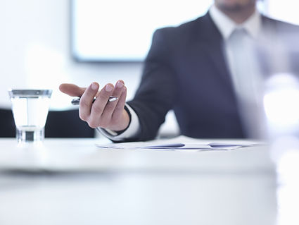 man in suit holding pen