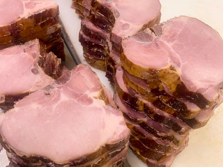 piles of smoked porkchops sitting on a table