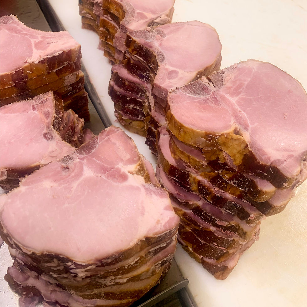 piles of smoked pork chops on a table