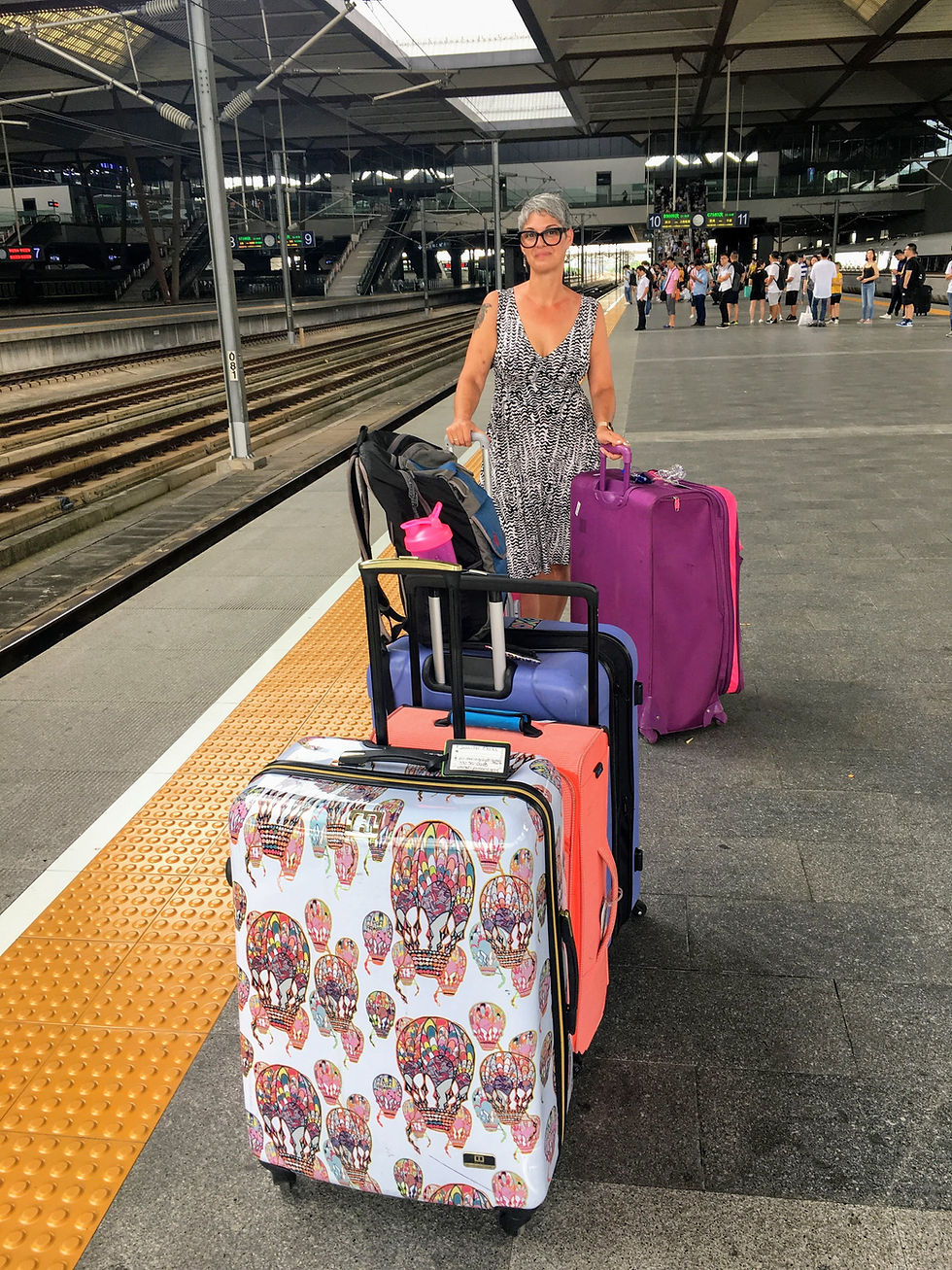 Jennifer & her bags at the train station.