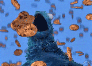 Cookie Monster joyfully catching falling cookies with its mouth.