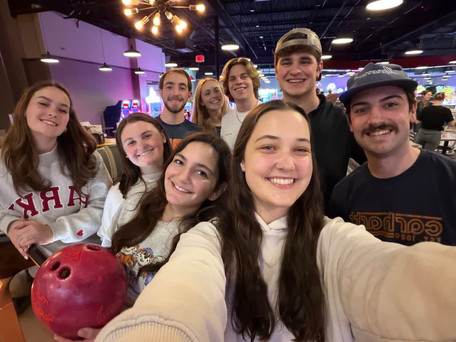 A group of friends taking a selfie after going bowling together.
