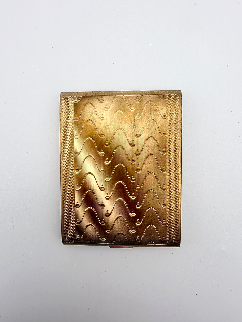 Mid-century Zenette gold tone brass rectangular powder compact closed top view