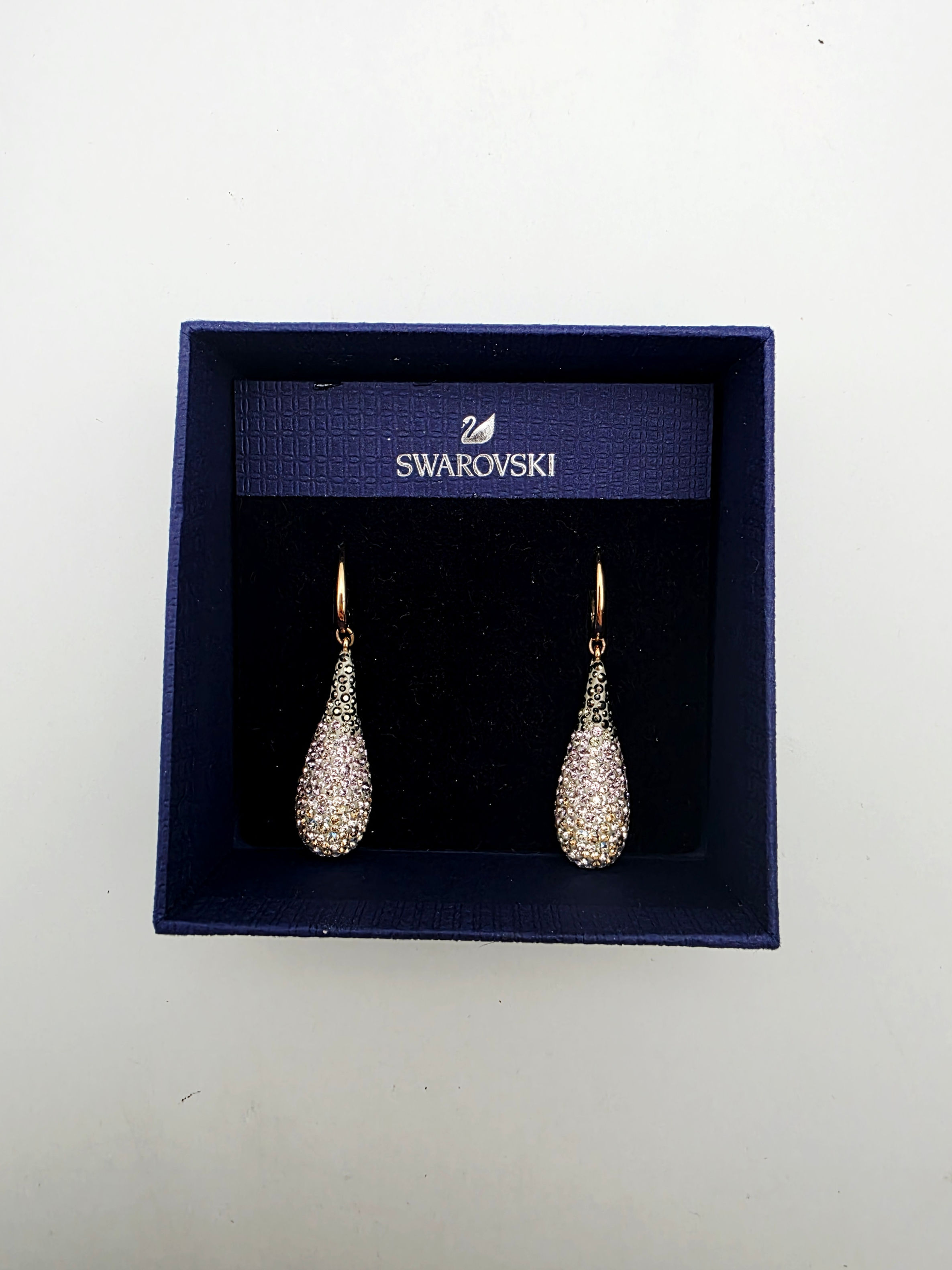 Authentic Swarovski ombré crystal teardrop drop earrings displayed in original navy blue box.