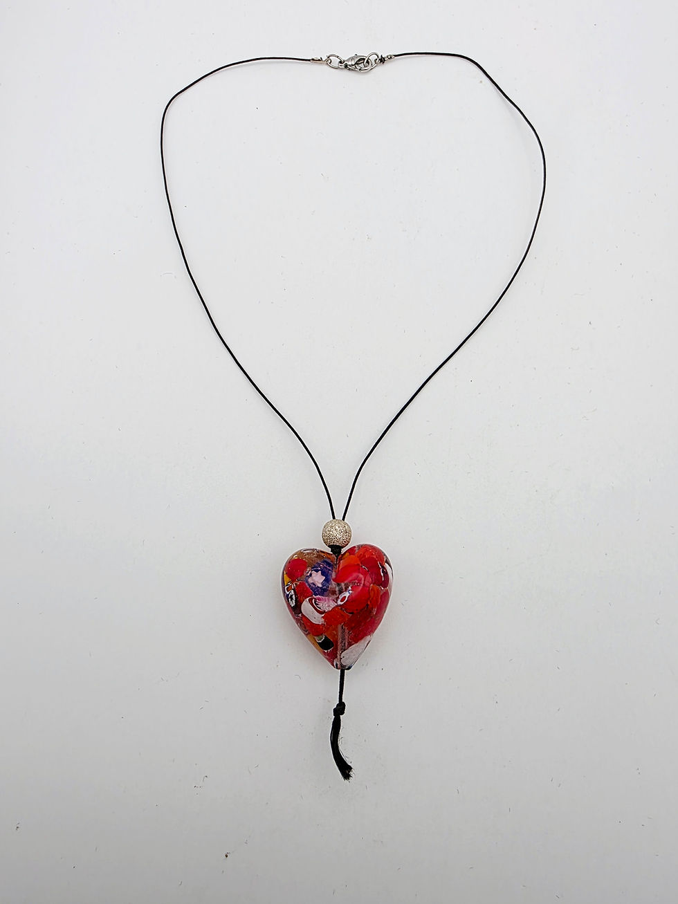 Thumbnail: Full view of vintage Millefiori glass heart pendant on fine black cord necklace