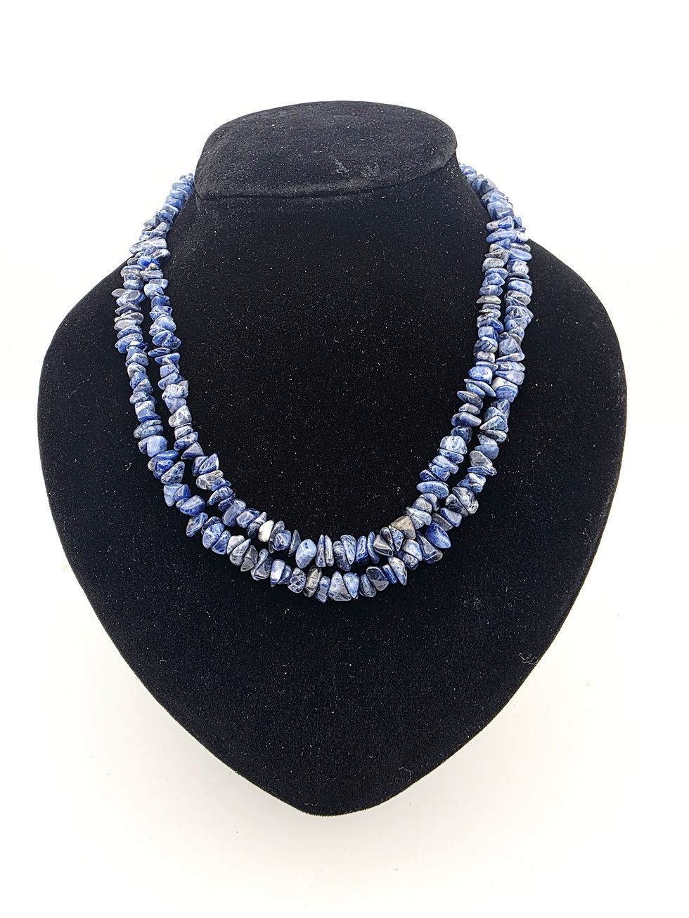 Front view of a continuous blue sodalite chip bead necklace displayed on a black bust.