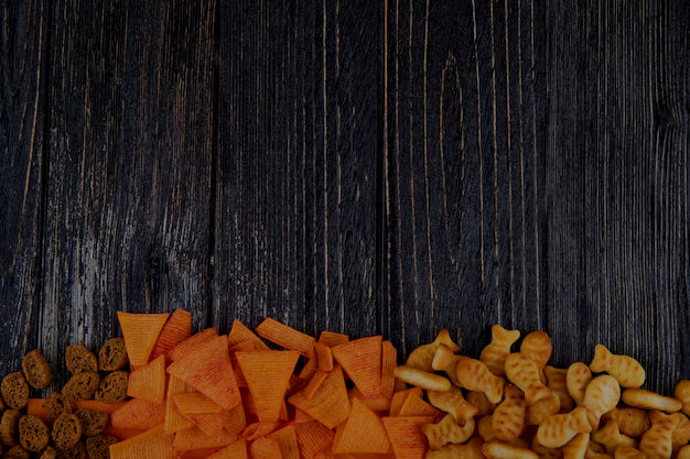 top-view-snacks-paprika-chips-hard-chuck-fish-crackers-bottom-with-copy-space-black-backgr