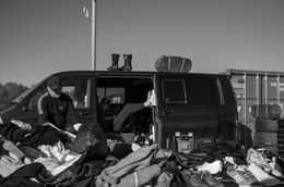 A black and white photo of a car boot sale stall.