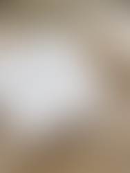 White Le Fournil pastry box resting on a beige blanket — the perfect setup for a cozy morning in.