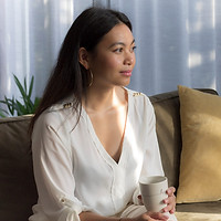 Entrepreneur portrait in golden light, relaxed at home with a coffee, capturing her calm and focused energy by StudioEnBlanco