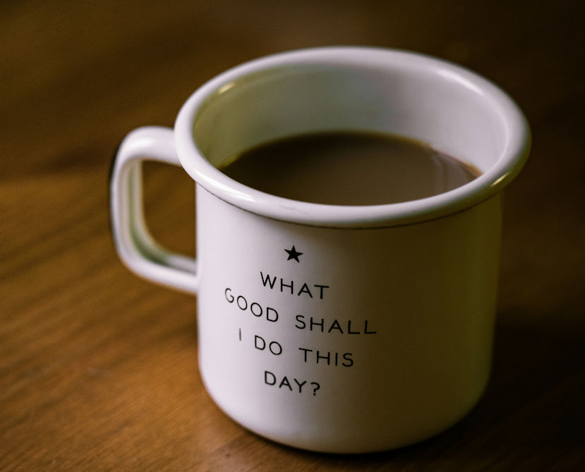 A coffee mug with the words "What Good Shall I Do This Day?"