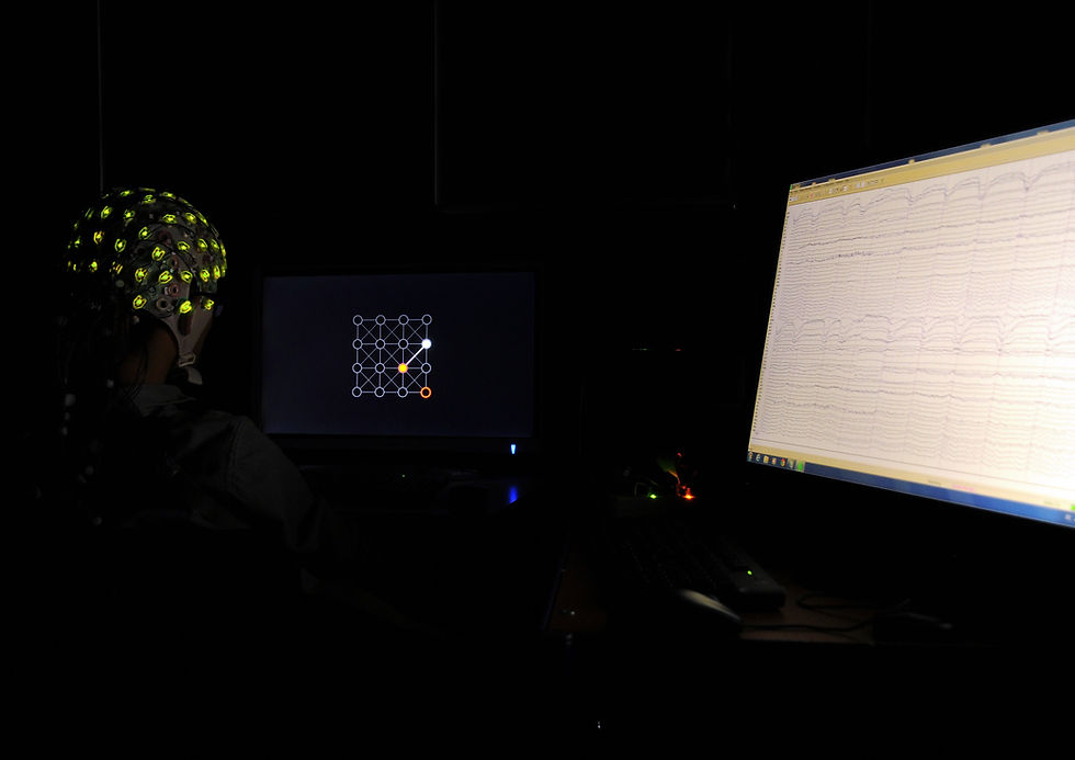 a research participant wearing an EEG cap that monitors and displays their brain activity