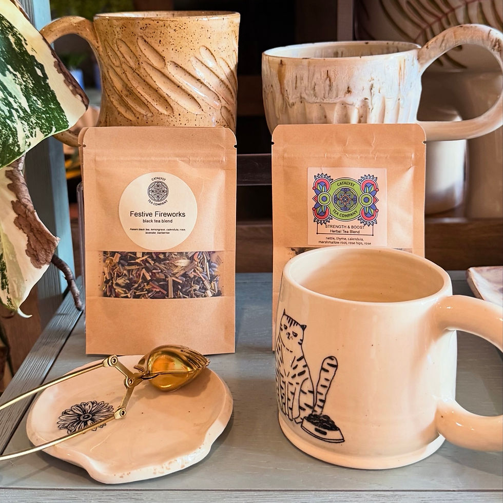 Catalyst Tea Festive Fireworks and Strength & Boost beside ceramic mugs at Spilled Milk