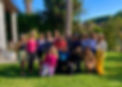 Group of 16 woman smiling in group photo at a retreat