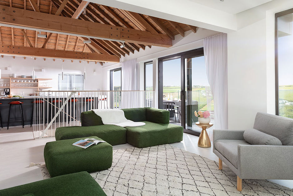 stylish and modern open plan living and kitchen space with metal balusdrades to stairs. 