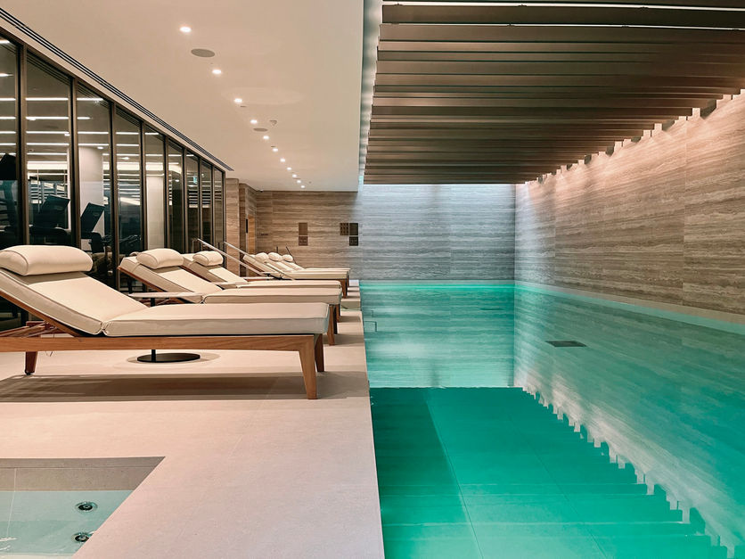 Pool view area with sauna and steam room by architects in London