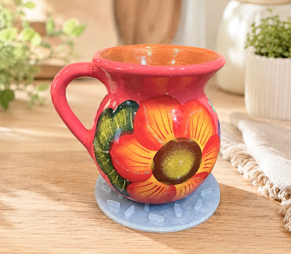 A flower pitcher resing on a sili solution mat on a table