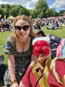 Festival visitor enjoying Southampton Thai Festival outdoor cultural event with crowd in background
