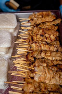 Thai street food grilled satay skewers cooking at Southampton Thai Festival food stalls
