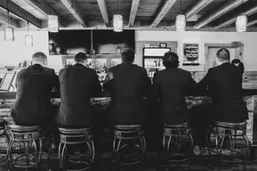 maine lakeside weddings groomsmen at bar