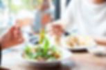 a couple eating vegan food in a restaurant