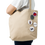 Thumbnail: Person holding beige tote bag with buttons featuring various designs.