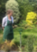 Sue standing in a garden