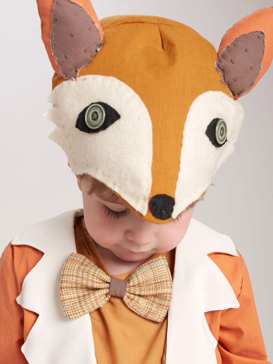 Young child wearing a fox costume with a bow tie