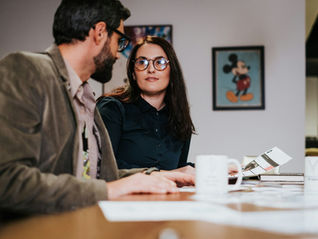 Two people in an office looking at each other