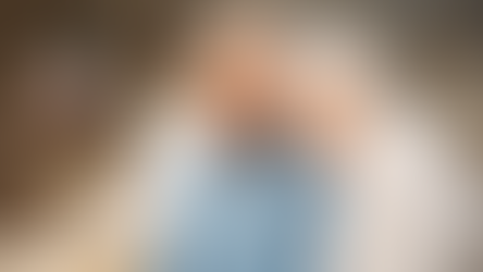 A retired couple happily laughing while looking at a distance, showing the ease of their retirement years.