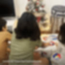 children opening a gift box from the Toronto Star Santa Claus Fund